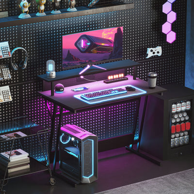 HOMCOM Gaming Desk with LED Lights and Power Outlets, 100 x 60cm Z Shaped Computer Desk with Monitor Stand and Steel Frame, PC Gaming Table for Home Office, Black 